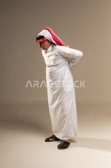 Elderly Saudi Man with Back Pain in Studio
