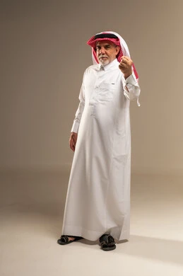 Senior Saudi Man in Traditional Thobe Making Hand Gesture
