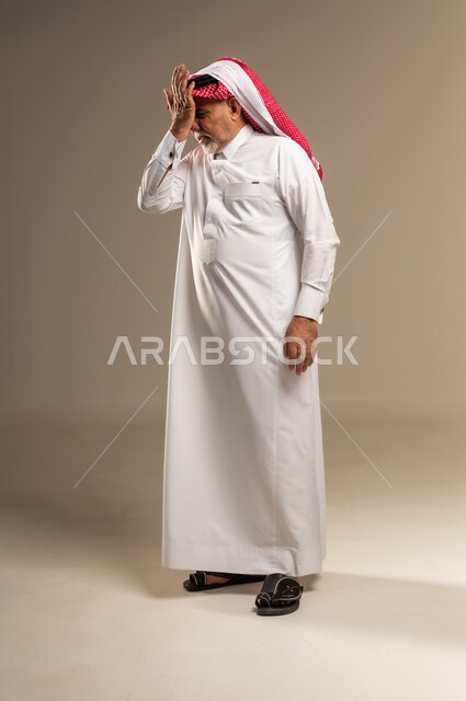 Elderly Saudi Man in Thobe Expressing Stress