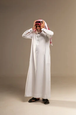 Elderly Saudi Man in Traditional Thobe Expressing Stress