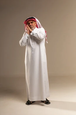 Elderly Saudi Man Making Sleeping Gesture in Studio