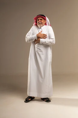 Elderly Saudi Man Feeling Chest Pain in Studio Background