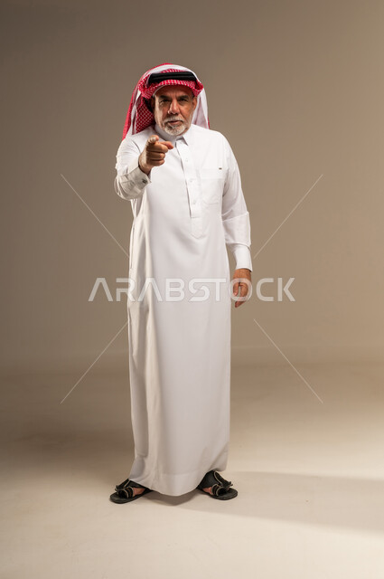 Senior Saudi Man Pointing Finger in Studio