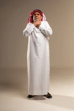 Senior Saudi Man Experiencing Choking in Traditional Thobe