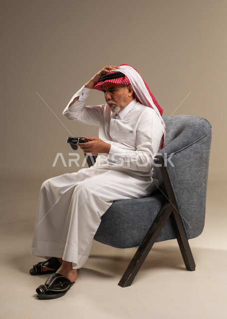 Elderly Saudi Man Frustrated Playing Video Games