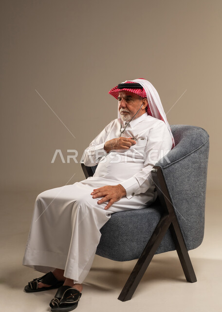 Elderly Saudi Man Using Stethoscope for Heart Check