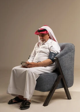 رجل سعودي مسن يقيس ضغط الدم في الاستوديو