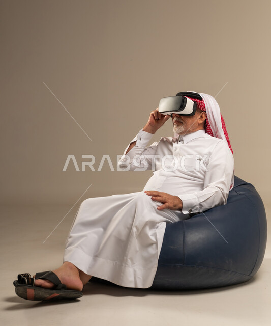 Senior Saudi Man Wearing Virtual Reality Headset in Studio