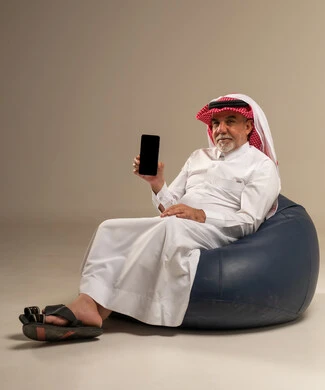 Senior Saudi Man with Smartphone on Bean Bag