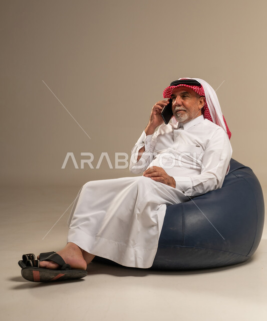 Senior Saudi Man Talking on Smartphone in Studio