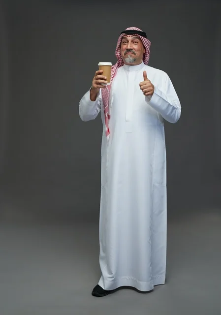 An elderly Arab Saudi Gulf man wearing a white thobe and a shemagh, holding a cup of coffee, with various gestures and signs, full body, gray background.