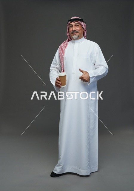 An elderly Arab Saudi Gulf man wearing a white thobe and a shemagh, holding a cup of coffee, with various gestures and signs, full body, gray background.