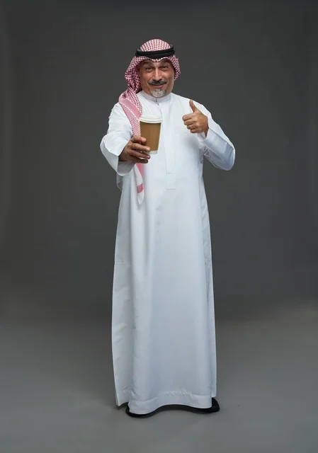 An elderly Arab Saudi Gulf man wearing a white thobe and a shemagh, holding a cup of coffee, with various gestures and signs, full body, gray background.