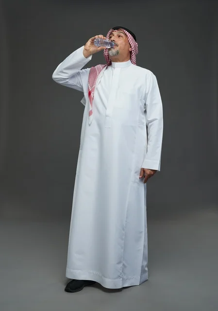 An elderly Arab Saudi Gulf man wearing a white thobe and a shemagh, holding a water bottle, with various gestures and signs, full body, gray background.
