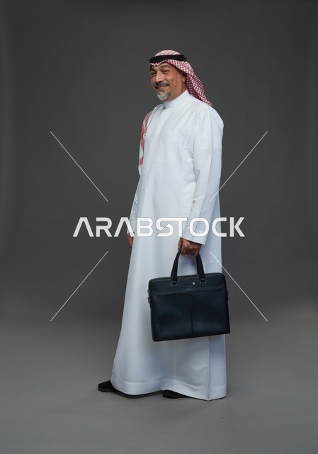 رجل اعمال عربي سعودي خليجي  يرتدي الزي الثوب الابيض والشماغ ويحمل حقيبة اللابتوب,  ايماءات واشارات مختلفه , كامل الجسم, خلفيه رماديه