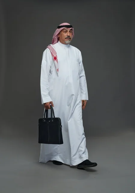 A Saudi Arabian Gulf businessman wearing a white thobe and a shemagh, carrying a laptop bag, with various gestures and signals, full body, gray background.