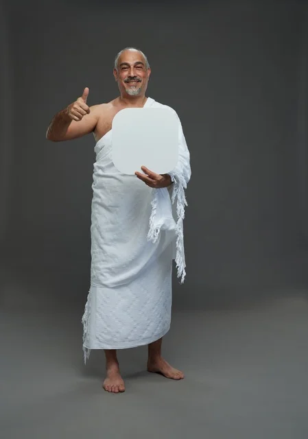 A portrait of a Saudi pilgrim in Ihram clothing holding a blank white square board while performing the rituals, with various gestures and signs, full body, gray background.