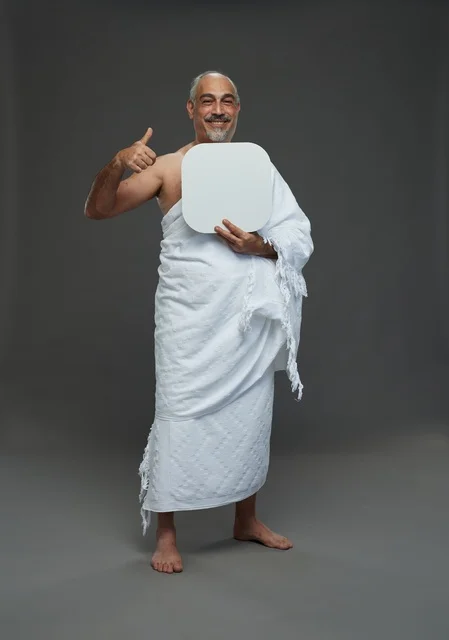 A portrait of a Saudi pilgrim in Ihram clothing holding a blank white square board while performing the rituals, with various gestures and signs, full body, gray background.