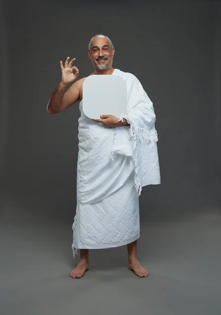 A portrait of a Saudi pilgrim in Ihram clothing holding a blank white square board while performing the rituals, with various gestures and signs, full body, gray background.