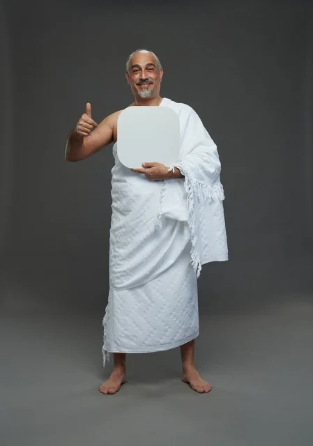 A portrait of a Saudi pilgrim in Ihram clothing holding a blank white square board while performing the rituals, with various gestures and signs, full body, gray background.