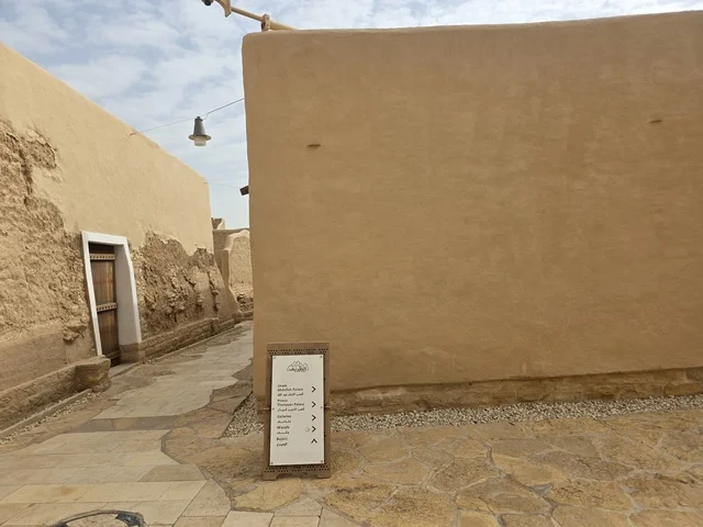 Clay structures built in the old style, green palm trees, the old walls of Diriyah in the city of Riyadh in the Kingdom of Saudi Arabia, ancient historical archaeological landmarks, ancient architectural engineering art, a picture of the archaeological buildings and clay houses in the Al-Turaif neighborhood in Diriyah.