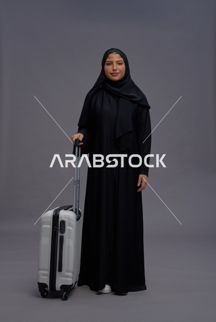 Saudi Woman with White Suitcase in Studio Portrait