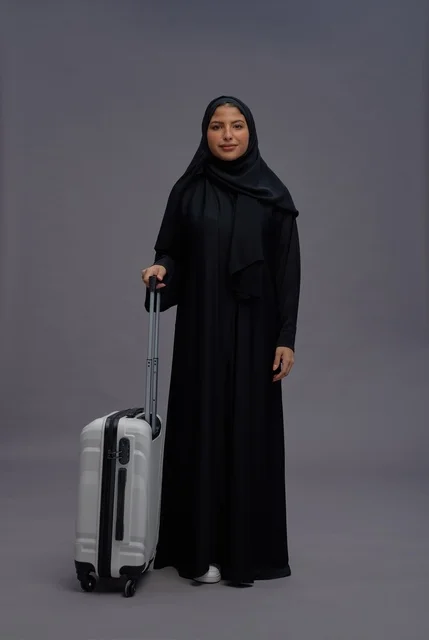 Saudi Woman with White Suitcase in Studio Portrait