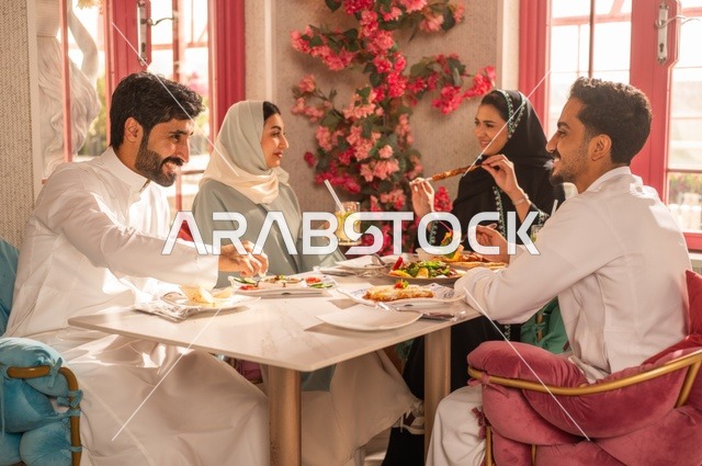 جلسة وناسة وتعارف، بناء علاقات اجتماعية ناجحة, تبادل الأحاديث والاخبار, مشاركة الأصدقاء الأوقات الممتعة, الاستمتاع بتناول الغداء في المطعم, عائلة عرب خليجيون سعوديون يجلسون على المائدة في إحدى المطاعم الراقية ويقومون بتناول الطعام بإيماءات السعادة والسرور