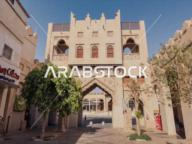 Tourist attraction areas, ancient historical landmarks, architectural designs in the old style, the Qaisariya market in the city of Al-Ahsa during the day, traditional archaeological souks, famous heritage tourist sites in the Kingdom of Saudi Arabia.