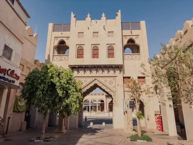 Tourist attraction areas, ancient historical landmarks, architectural designs in the old style, the Qaisariya market in the city of Al-Ahsa during the day, traditional archaeological souks, famous heritage tourist sites in the Kingdom of Saudi Arabia.