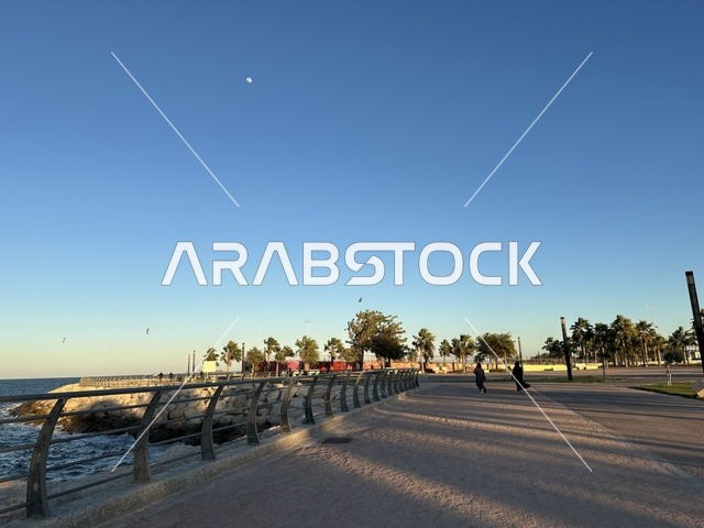 An area with trees and green plants, the waterfront in the city of Dammam at sunset, a vibrant area and a main outlet for the residents and visitors of the Eastern Province, a corniche overlooking the Arabian Gulf in the Kingdom of Saudi Arabia.
