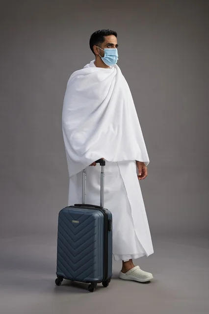 Arab Man in Ihram with Suitcase and Face Mask Studio Shot