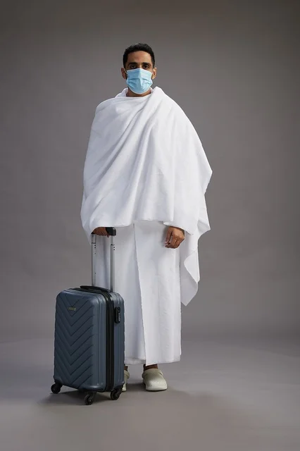Arab Man in Ihram with Suitcase and Medical Face Mask