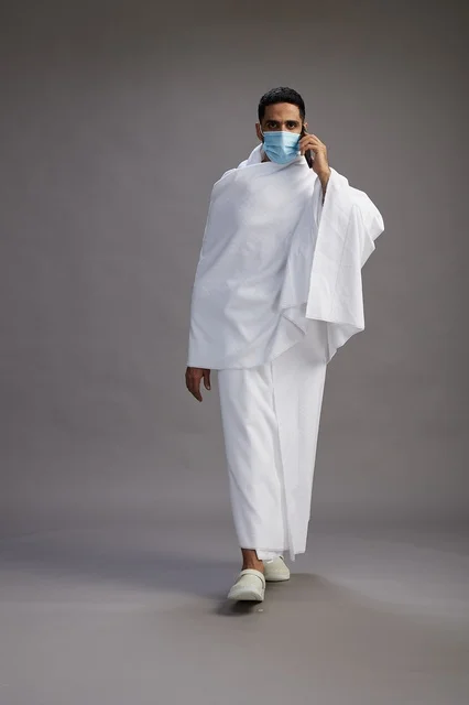 Arab Man in Ihram Talking on Phone wearing Face Mask