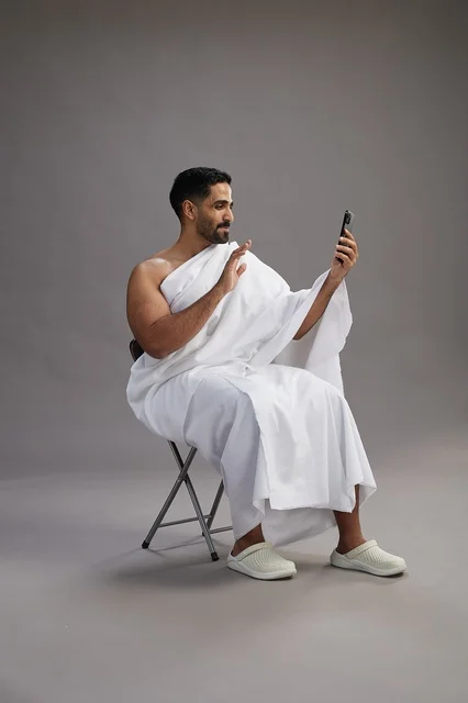 Saudi Man in Ihram Making Video Call on Smartphone