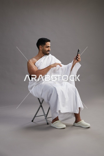 Saudi Pilgrim in Ihram Using Smartphone Video Call