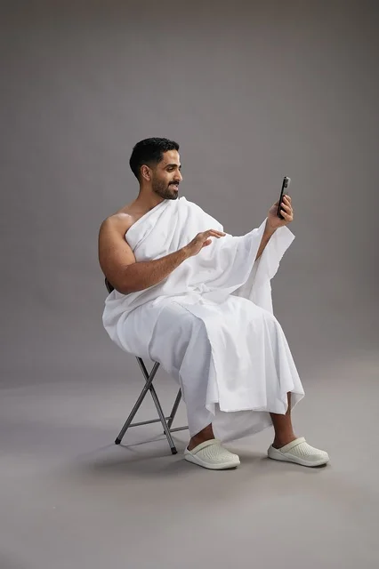 Saudi Pilgrim in Ihram Making Video Call on Smartphone