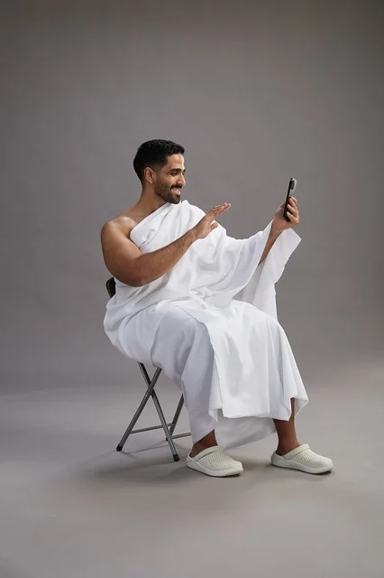 Saudi Pilgrim in Ihram Making Video Call in Studio