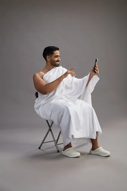 Saudi Pilgrim in Ihram Making Video Call in Studio