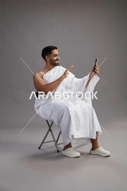 Saudi Pilgrim in Ihram Making Video Call on Smartphone