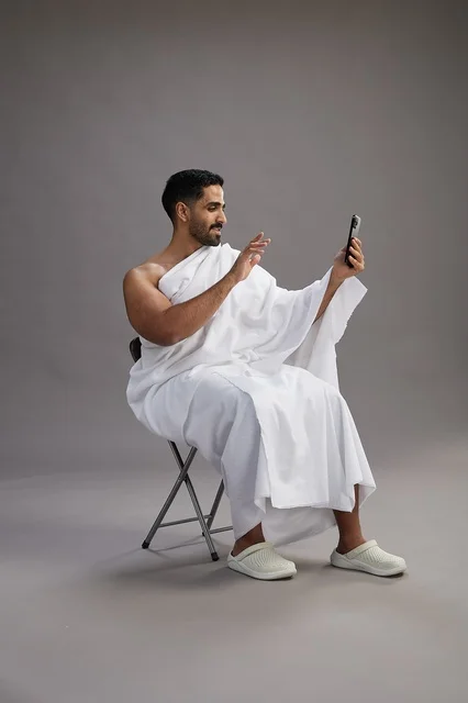 Saudi Pilgrim in Ihram Making Video Call