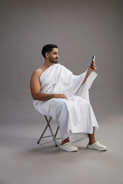 Saudi Pilgrim in Ihram Making Video Call on Smartphone