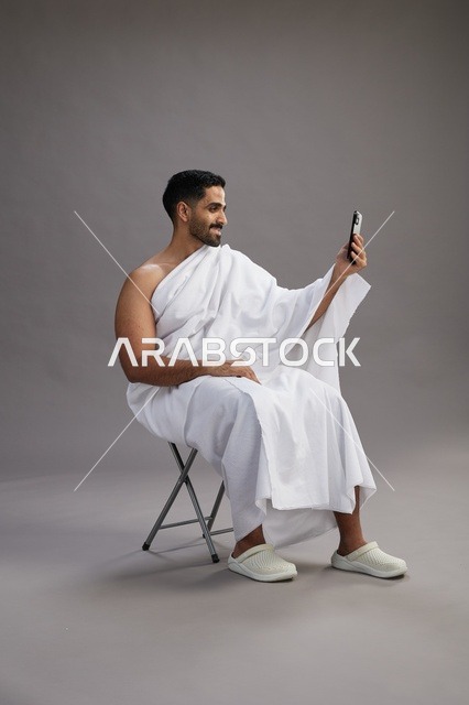 Saudi Pilgrim in Ihram Making Video Call