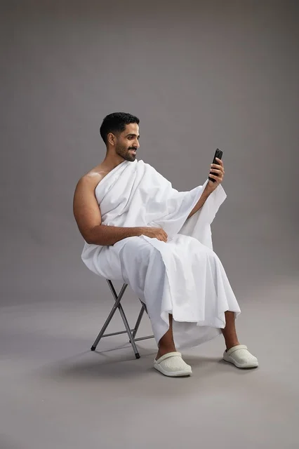 Saudi Pilgrim in Ihram Making Video Call on Smartphone