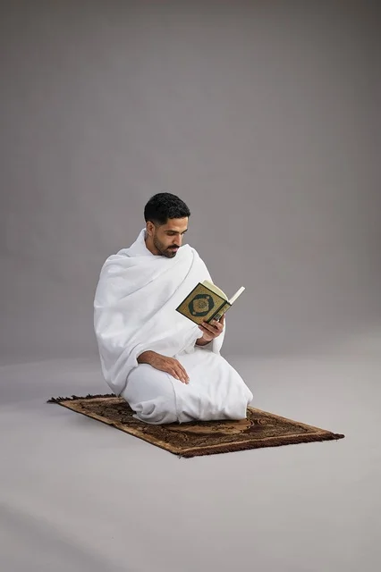 Saudi Pilgrim in Ihram Reading Quran in Studio