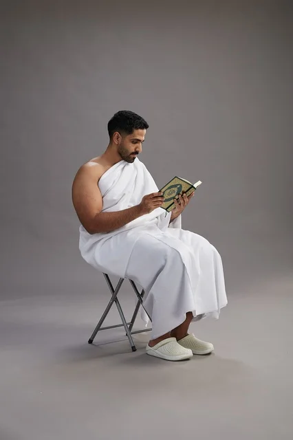 Saudi Pilgrim in Ihram Reading Holy Quran in Studio