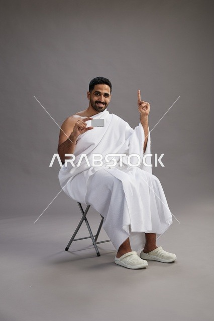 حاج سعودي بملابس الإحرام يحمل بطاقة ائتمان
