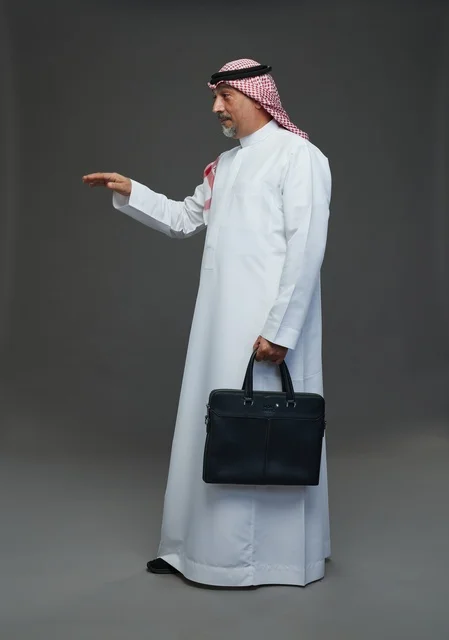 A Saudi Arabian Gulf businessman wearing a white thobe and a shemagh, carrying a laptop bag, with various gestures and signals, full body, gray background.