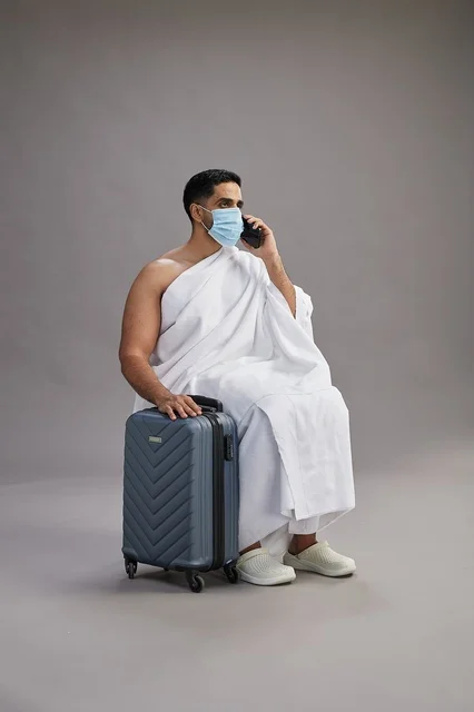 Arab Pilgrim in Ihram with Suitcase and Mask Studio Shot