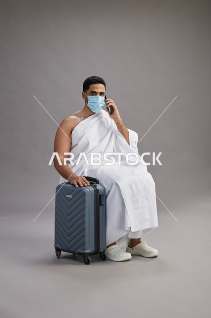 Saudi Man in Ihram with Suitcase and Mask